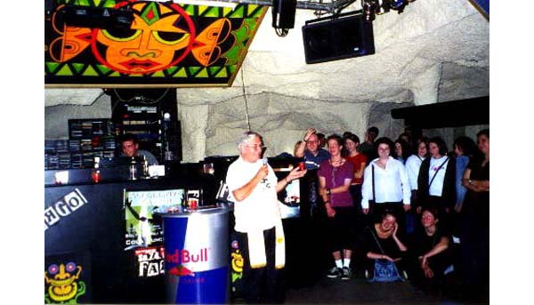 A priest giving a homily in a discotheque
